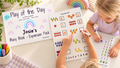 Personalised Busy Book Expansion Pack with a child counting fruit on a laminated page